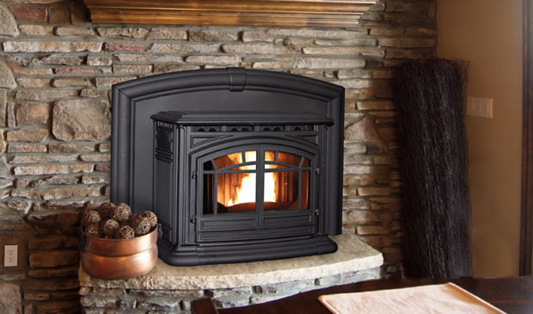 Cozy living room with a black wood-burning stove in a stone fireplace and rustic decor.
